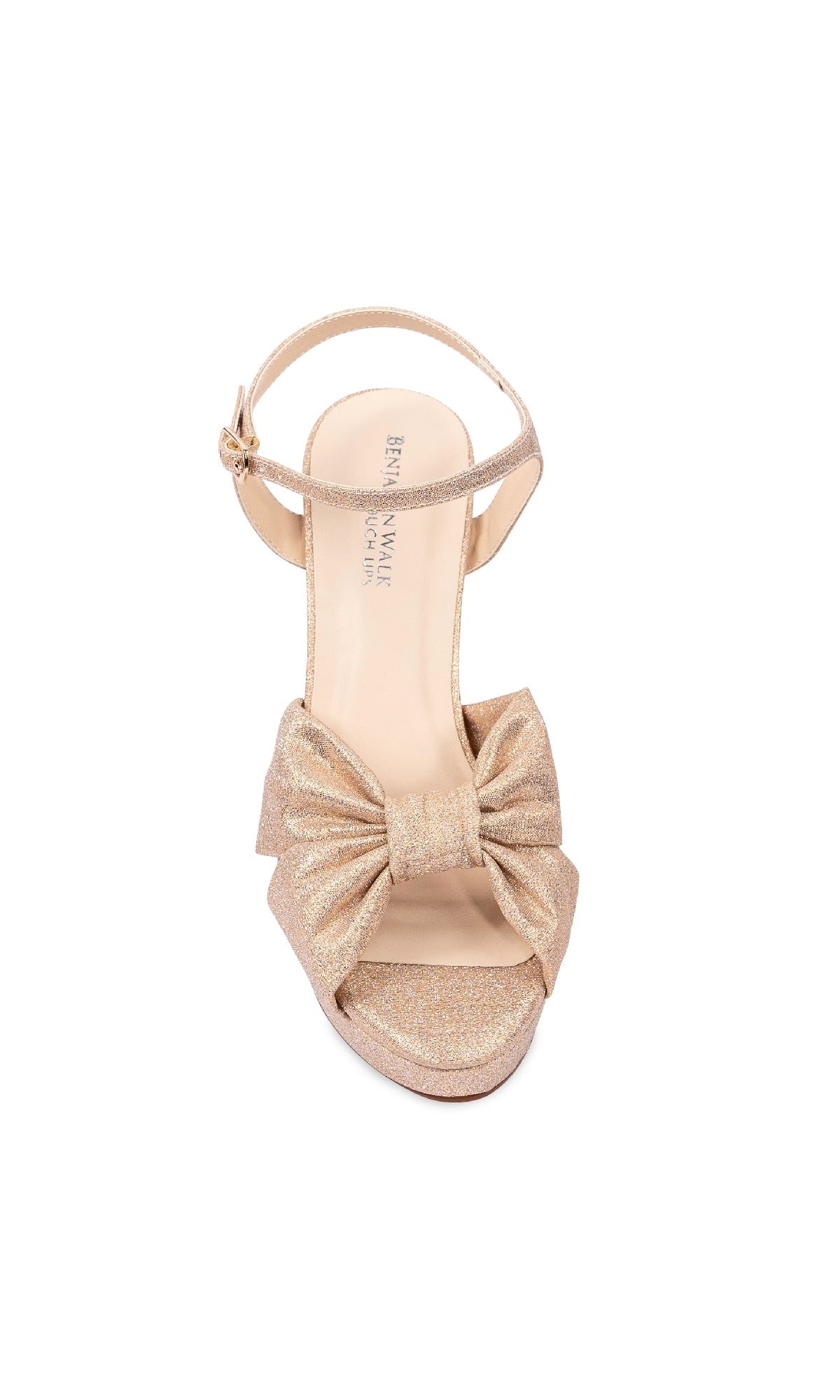 The Sailor Champagne Shimmer Shoes (Touch Ups 4662) are gold, glittery open-toe high-heel sandals with an ankle strap and a large front bow—perfect for prom.